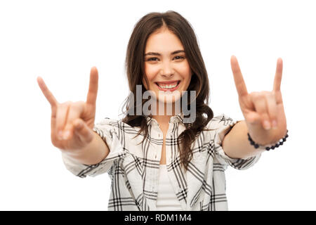 young woman or teenage girl showing rock sign Stock Photo