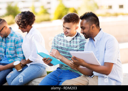 international students with notebooks outdoors Stock Photo