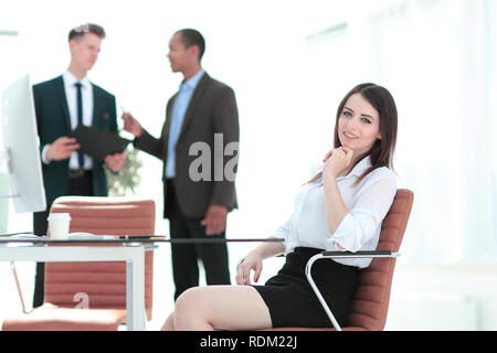 successful business woman sitting at Desk in her office Stock Photo