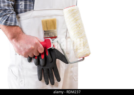 House painter worker with white work overalls, keeps the roller to paint in his hand. Isolated on white background. Text space Stock Photo