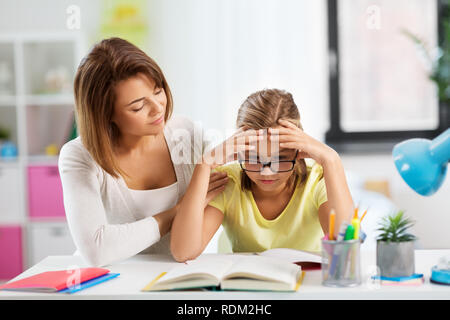 mother helping daughter with difficult homework Stock Photo