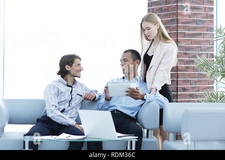 business team reading text on a digital tablet Stock Photo