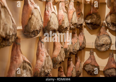 Raw hanging prosciutto Stock Photo