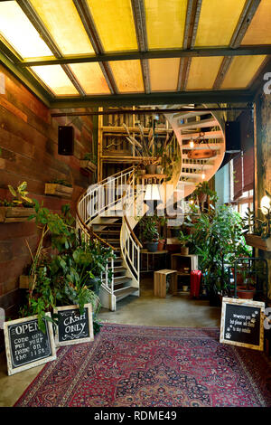 Berlin Germany - November 12, 2018. Interior view of the lobby of House of Small Wonder cafe in Berlin, with spiral staircase leading to the main hall Stock Photo
