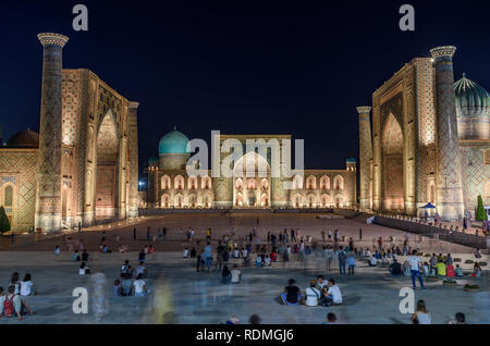 Registan Square at night, with imposing Madrasa buildings, Ulugh Beg Madrasah, Sher-Dor Madrasah and the Tilya Kori Madrasah, Samarkand. Stock Photo