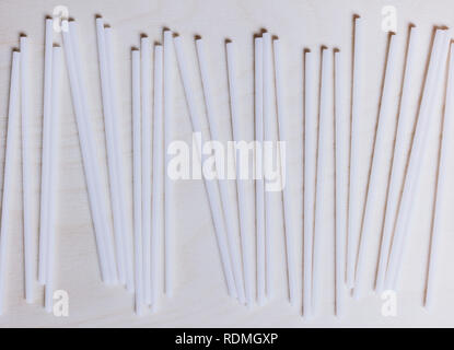 Overhead shot of white drinking straws lined up in rows. Stock Photo