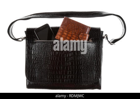 Phone and wallet sticks out of the pocket of a leather bag. Isolated on white background Stock Photo