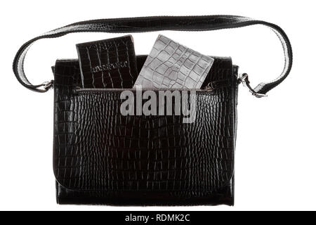 Passport and wallet sticking out of the pocket of a leather bag. Isolated on white background Stock Photo
