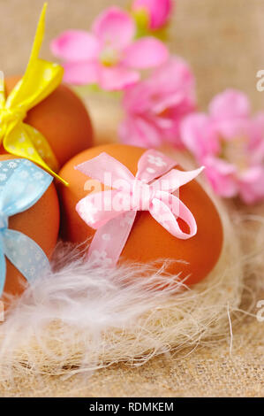 Easter eggs in the nest on a burlap Stock Photo