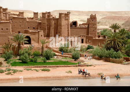 Tourists Visiting Ksar of Aït-Ben-Haddou aka Ait Benhaddou, an Adobe Earth Clay Built Fortified Village or Ighrem, and Popular Film Location Morocco Stock Photo