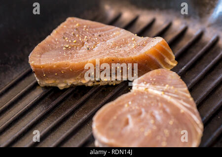 Close Up Of Chargrilled Tuna Steaks Cooking In A Griddle Pan With Seasoning Stock Photo Alamy