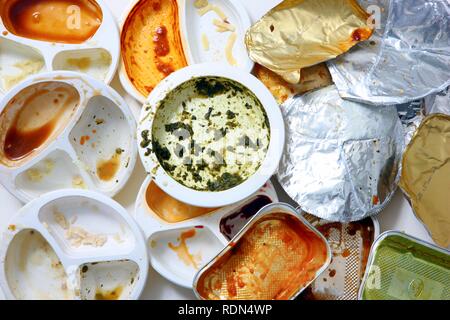 Used packaging, remains of prepared meals, convenience food, plastic and aluminum trash Stock Photo