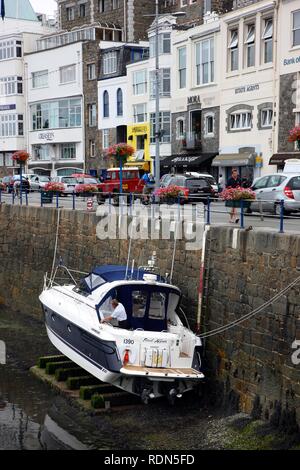 Boat lying dry in the marina at low tide, main port, St. Peter Port, Guernsey, Channel Islands, Europe Stock Photo