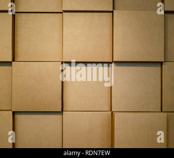 Cardboard boxes stacked in a wall. Background Stock Photo