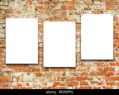 Three blank frames on orange weathered brick wall background Stock Photo