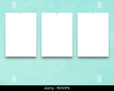 Three blank frames on aqua plaster wall background Stock Photo