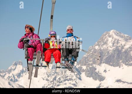 Young family in the chairlift to the Planai, Dachstein Mountains, Alps, Styria, Austria, Europe Stock Photo