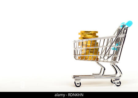 A shopping cart full of golden coins on a white background Stock Photo