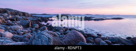 Rocky shoreline at sunset Stock Photo
