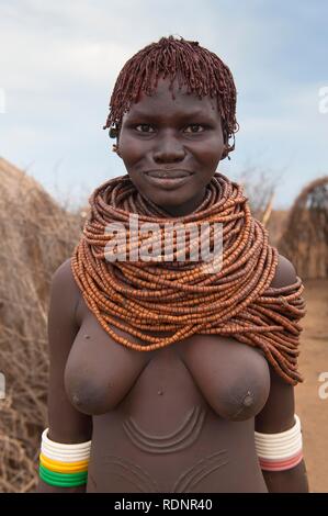 Nyangatom, Bume or Buma woman with bead necklaces in her village, Omo Valley, Ethiopia, Africa Stock Photo