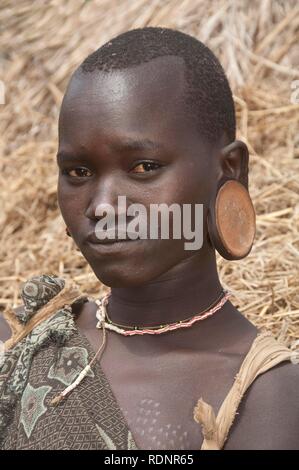 Surma woman wearing earplates, Kibish, Omo valley Valley, Ethiopia, Africa Stock Photo