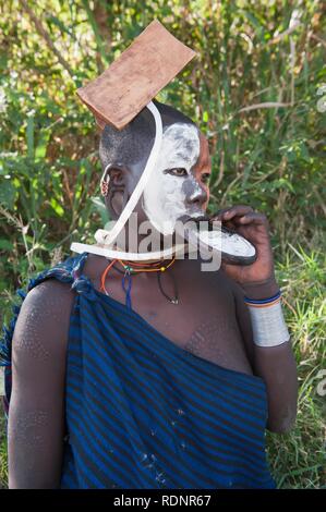 Surma woman with rounded lip plate, Kibish, Omo valley Valley, Ethiopia, Africa Stock Photo