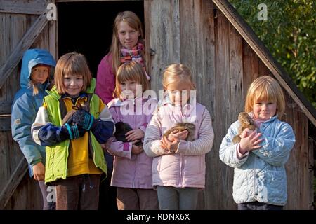 Young girls cuddling with rabbits Stock Photo