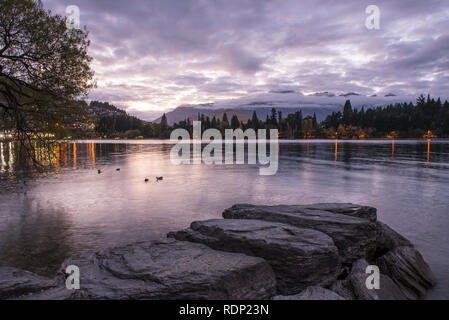 Scene along the waterfront of Lake Wakatipu in Queenstown on the South Island of New Zealand. Stock Photo