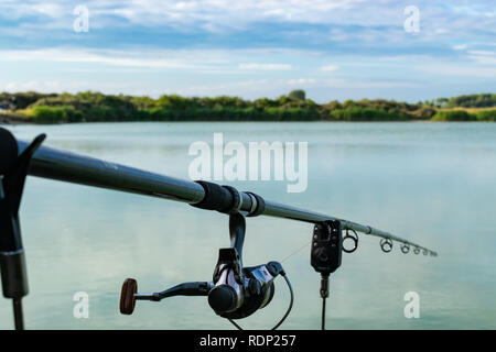 Fishing rod closeup on a prop and water background Stock Photo - Alamy