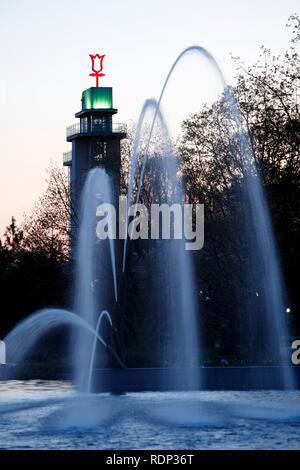 Grugaturm tower and water games in the evening, Grugapark, large park in the city, Essen, North Rhine-Westphalia Stock Photo