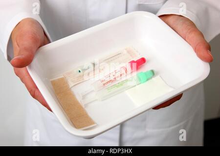 Medical practice, laboratory, blood analysis, medical technician, cannulas and test tubes for taking blood samples Stock Photo