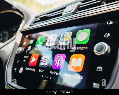 PALMA DE MALLORCA, SPAIN - MAY 10, 2018: Side view of large dashboard computer screen with apps buttons on the Apple CarPlay main screen in modern car dashboard  Stock Photo