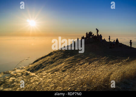 Colorful sunset over a sea of clouds, Mission Peak, south San Francisco bay area, California Stock Photo