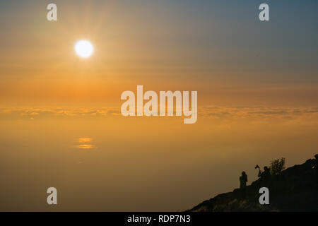 Colorful sunset over a sea of clouds, Mission Peak, south San Francisco bay area, California Stock Photo
