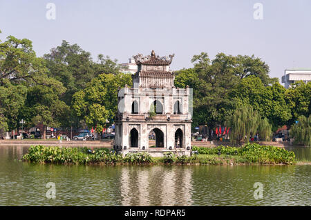 Thap Rua Turtle Tower island on Hoan Kiem Lake with city in background, Hanoi, Vietnam