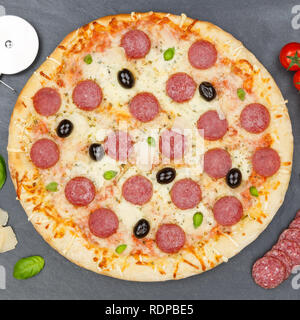 Pizza pepperoni salami from above square baking ingredients on a slate Stock Photo
