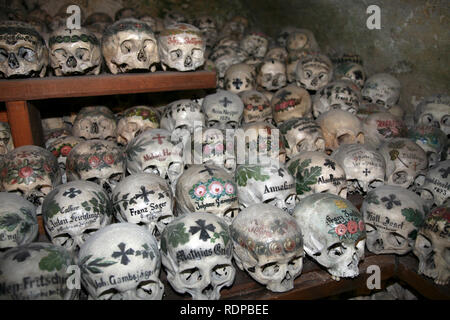 Painted skulls in the Ossuary or Beinhaus in Hallstatt, Austria, Europe Stock Photo