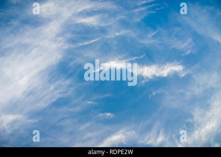 White cirrus clouds on a blue sky background Stock Photo