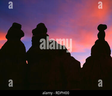 USA, Utah, Bryce Canyon National Park, Sunset colored clouds rise above silhouetted hoodoos in the Queens Garden. Stock Photo