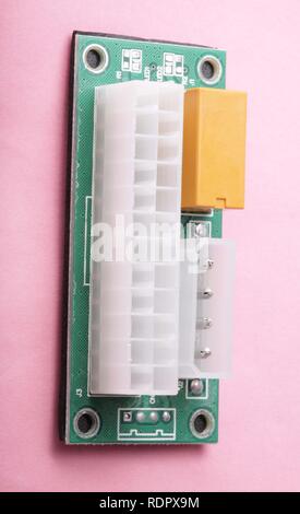 Mining ATX 24Pin Dual PSU Power Supply Sync Starter on pink background Stock Photo