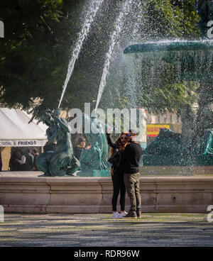 A couple taking a picture on the Rossio square in Lisbon, Portugal Stock Photo