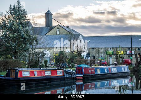 Canal boats on the River Stort in Sawbridgeworth in front of old maltings buildings. Stock Photo