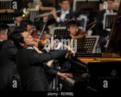 Saudi Arabia. 19th January 2019. (190119) -- AL-ULA, Jan. 19, 2019 (Xinhua) -- Chinese pianist Lang Lang performs at the historic city of Al-Ula in Saudi Arabia on Jan. 18, 2019. As part of the 'Winter at Tantora' festival, Lang and the Guangzhou Symphony Orchestra dazzled music lovers on Friday night at the UNESCO World heritage site in northwestern Saudi Arabia. 'Winter at Tantora' is a local music event in Al-Ula, a small town next to the ancient Nebatean site of Madein Saleh, where a number of weekend cultural and musical events are held. TO GO WITH Feature: World-renowned Chinese pianist  Stock Photo