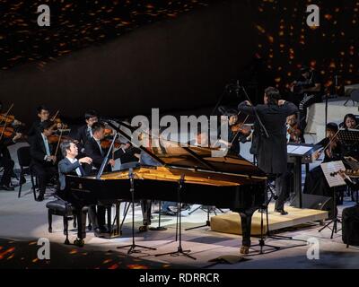 Saudi Arabia. 19th January 2019. (190119) -- AL-ULA, Jan. 19, 2019 (Xinhua) -- Chinese pianist Lang Lang and the Guangzhou Symphony Orchestra perform at the historic city of Al-Ula in Saudi Arabia on Jan. 18, 2019. As part of the 'Winter at Tantora' festival, Lang and the Guangzhou Symphony Orchestra dazzled music lovers on Friday night at the UNESCO World heritage site in northwestern Saudi Arabia. 'Winter at Tantora' is a local music event in Al-Ula, a small town next to the ancient Nebatean site of Madein Saleh, where a number of weekend cultural and musical events are held. TO GO WITH Feat Stock Photo