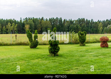 Anyksciai, Lithuania - September 8, 2018: Rabbit, swan, vase and mushroom shaped bushes in a topiary garden. Green figures made of arborvitae. Stock Photo
