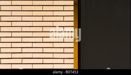 A white tiled wall with orange stripes and gray area Stock Photo