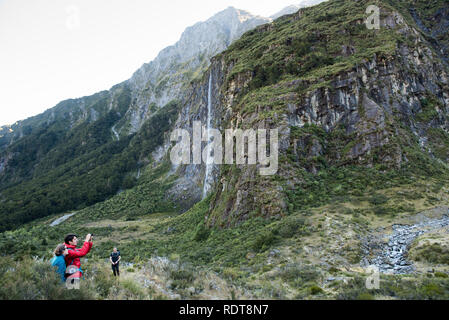 The Rob Roy Glacier Track leads hikers through a beech forest into a basin underneath the Rob Roy Glacier with waterfalls and views of Mount Aspiring  Stock Photo