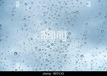 Raindrops on the windshield; in the background cloudy sky, California Stock Photo