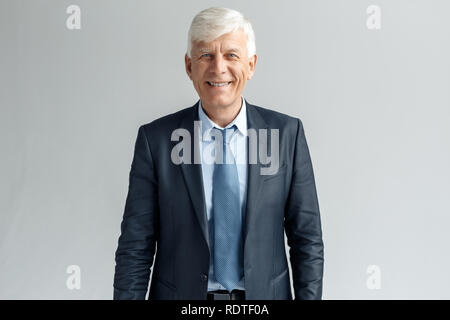 Business Lifestyle. Businessman standing isolated on gray looking camera cheerful Stock Photo