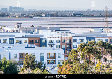 New residential developments on the shoreline of San Francisco bay area; salt evaporation ponds in the background; Silicon Valley, California Stock Photo